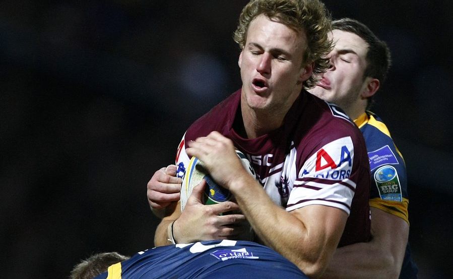 Manly's Daly Cherry-Evans (center) is tackled by Leeds' Paul McShane during a World Club Challenge rugby league match in 2012. Manly's Daly Cherry-Evans (center) is tackled by Leeds' Paul McShane during a World Club Challenge rugby league match in 2012.
